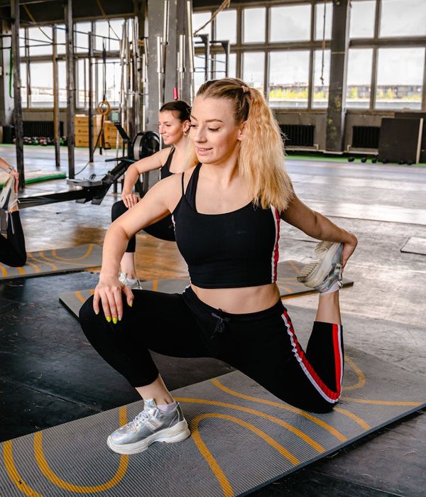Man stretching with a smile, looking energetic and full of life.