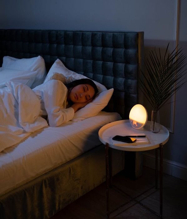 Woman meditating peacefully in a calm, minimalist environment.